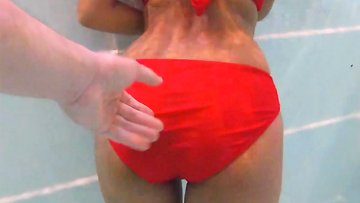 Amateur teen couple foreplay in a public pool and sex