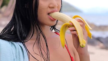 Slim mountainous boobs Asian teen Kahlisa sucking banana after sexy strip