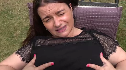 Busty granny dildoes her self while spreading legs outdoor
